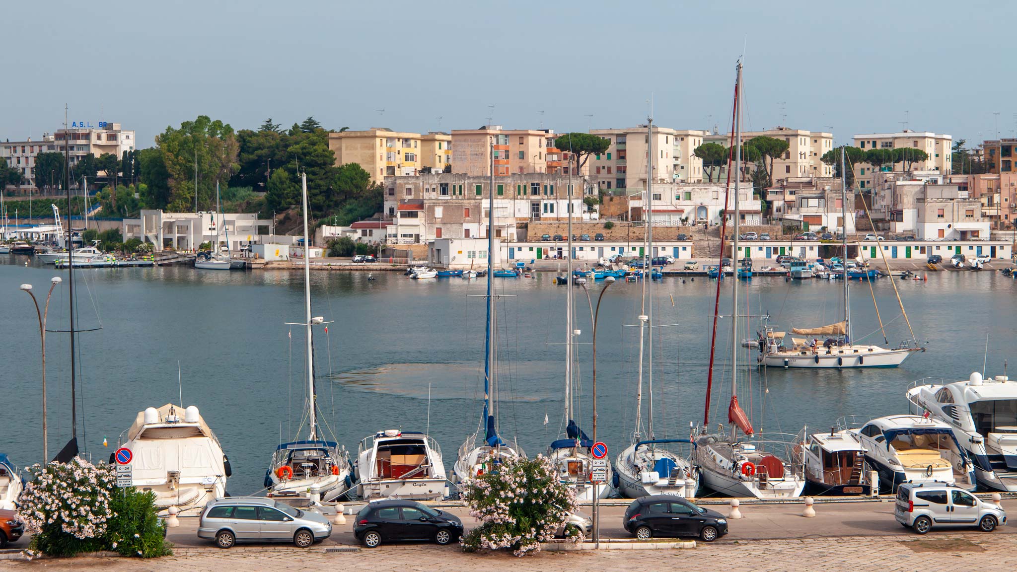 A row of boats in Brindisi frame the harbour