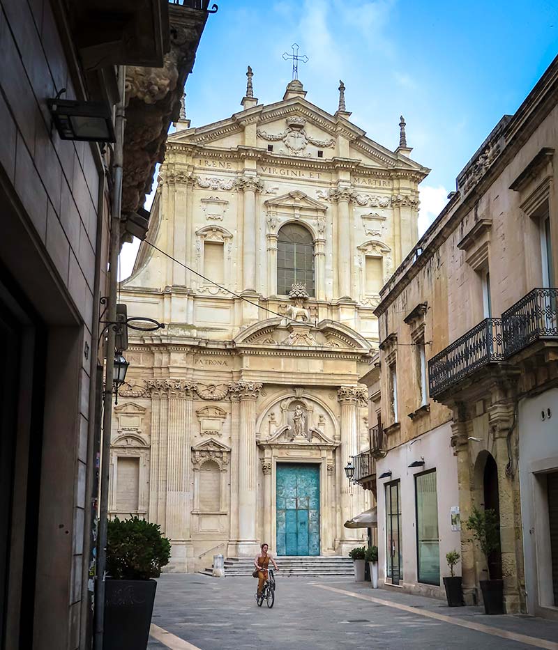 A bicycle and a church in Lecce Puglia at sunrise