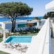 Looking out on the Atlantic ocean and an infnity pool with two white luxury villas in the picture at Lux Mare