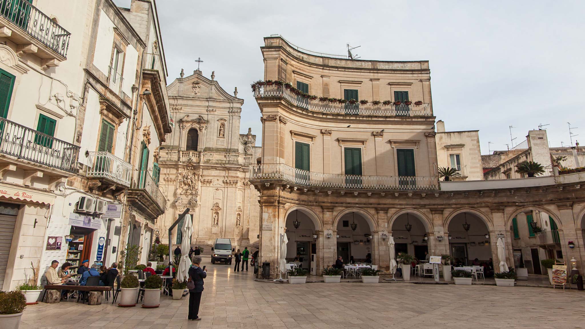 The main square of Martina Franca Puglia with arches and a cathedral