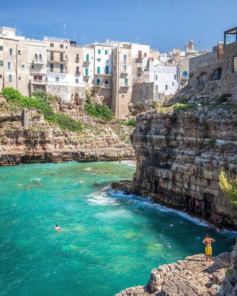 People enjoying the waters of Puglia and jumping off cliffs