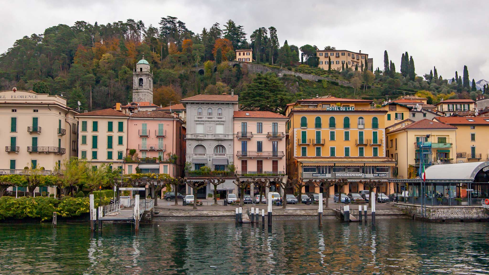 Colourful houses against a green mountain make up the small village of Bellagio on Lake Como