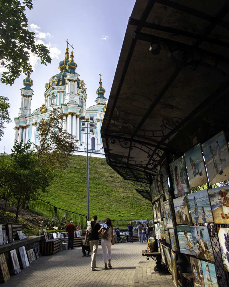 A cathedral in Kyiv Ukraine framed by an art stool on the bottom right