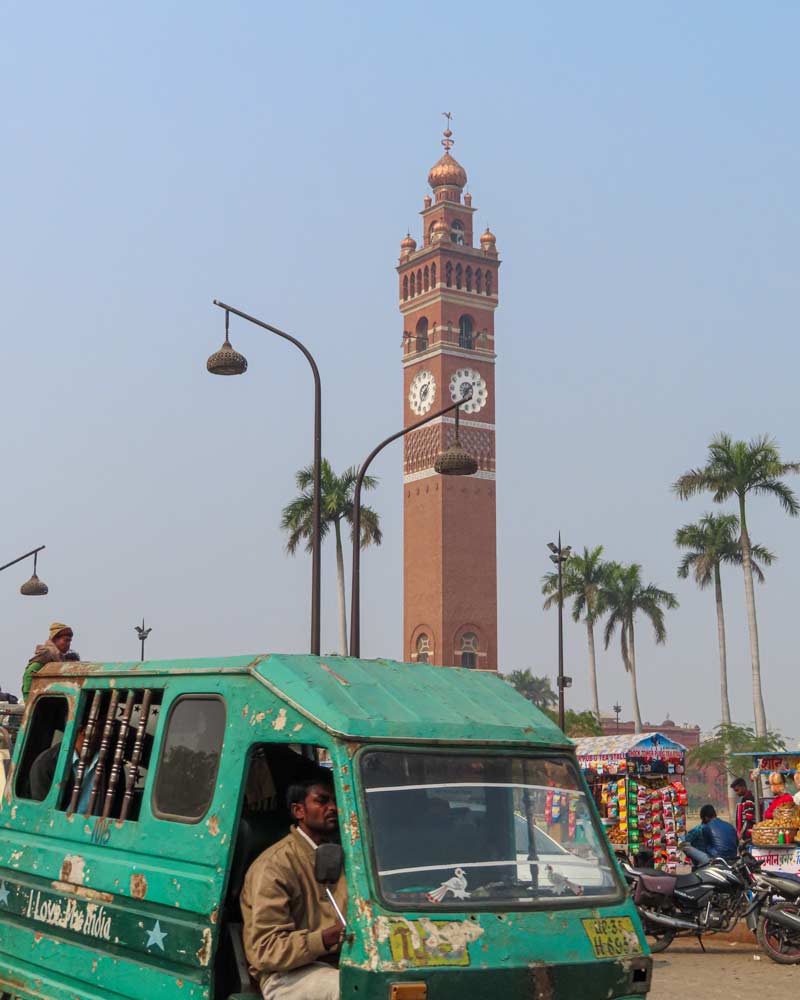 The Ghanta Ghar is a clocke tower which stands behind a green minibus