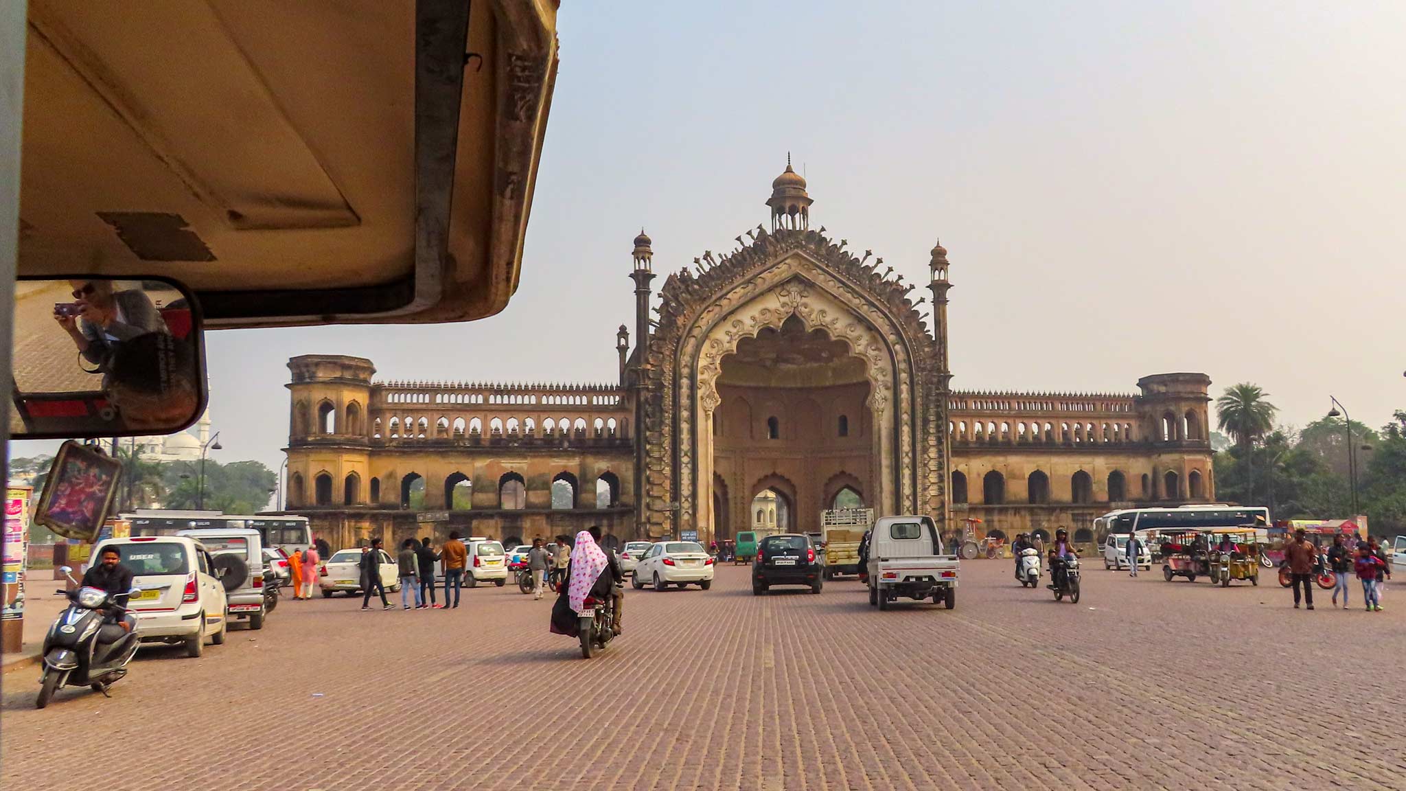 The Rumi Darwaza Gate, a large gate to the city on the road, as seen from an auto rickshaw