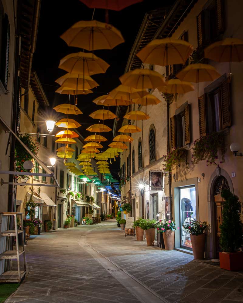 Bagni-di-Romagna Bagno di Romagna by night with umbrellas hanging in a street