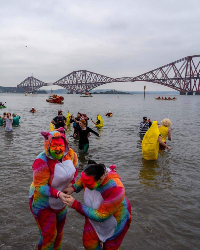 Dookers in their fancy dress costumes in front of the Forth bridge