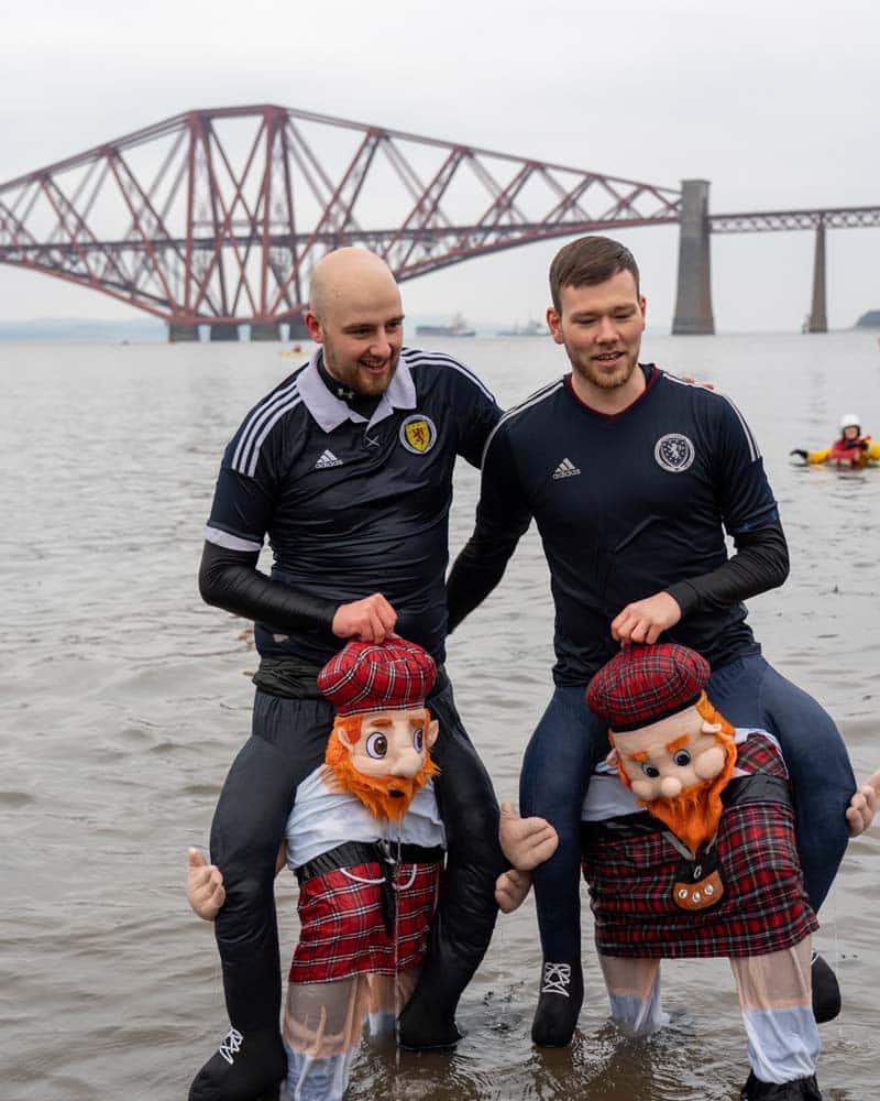 Dookers in their fancy dress costumes in front of the Forth bridge