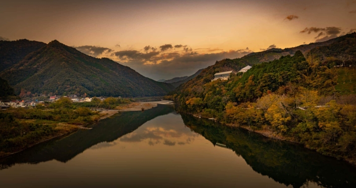 Sunset on the Shimanto river in Kochi Japan, with the mountains reflecting in the water