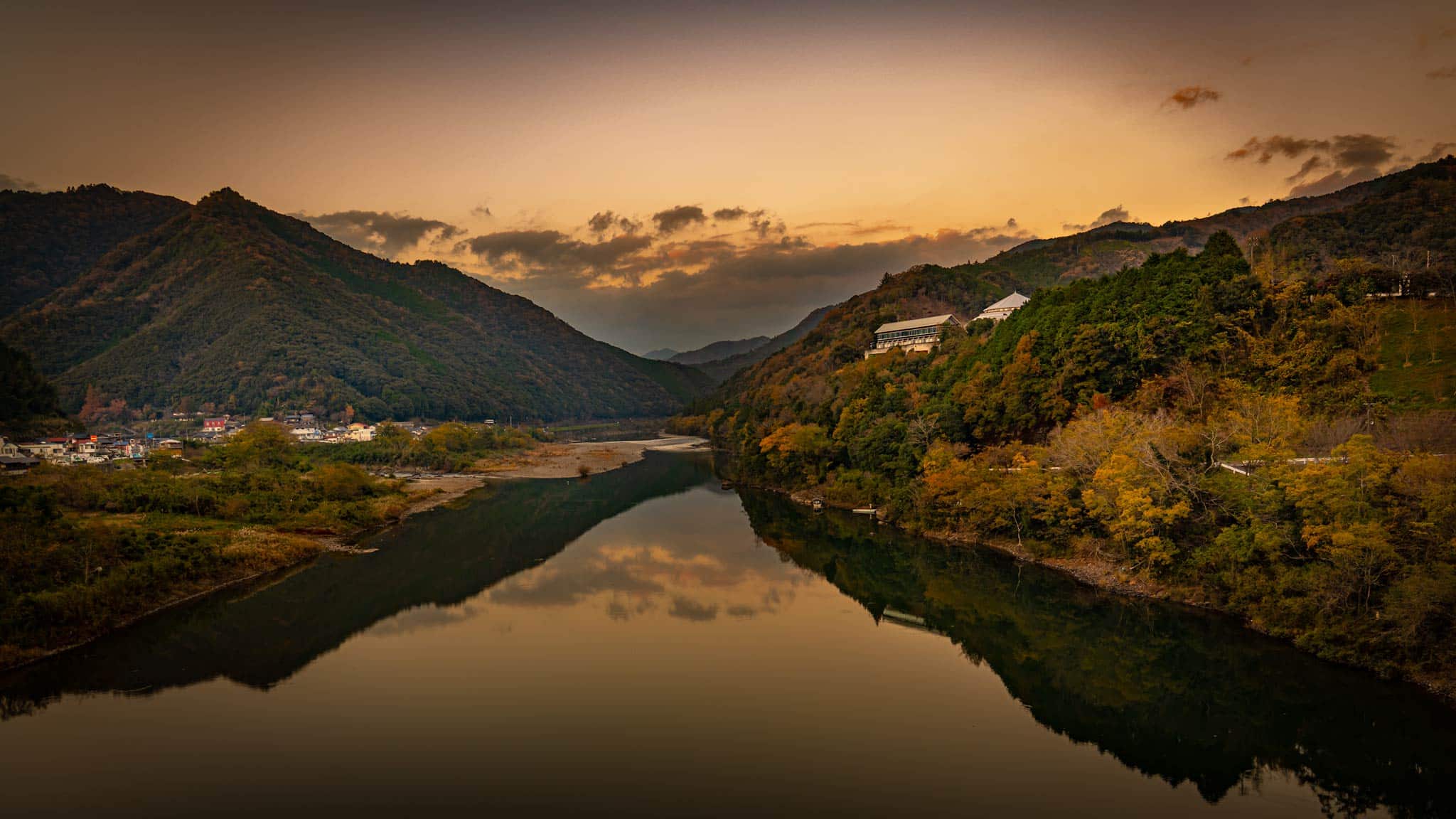 Sunset on the Shimanto river in Kochi Japan, with the mountains reflecting in the water