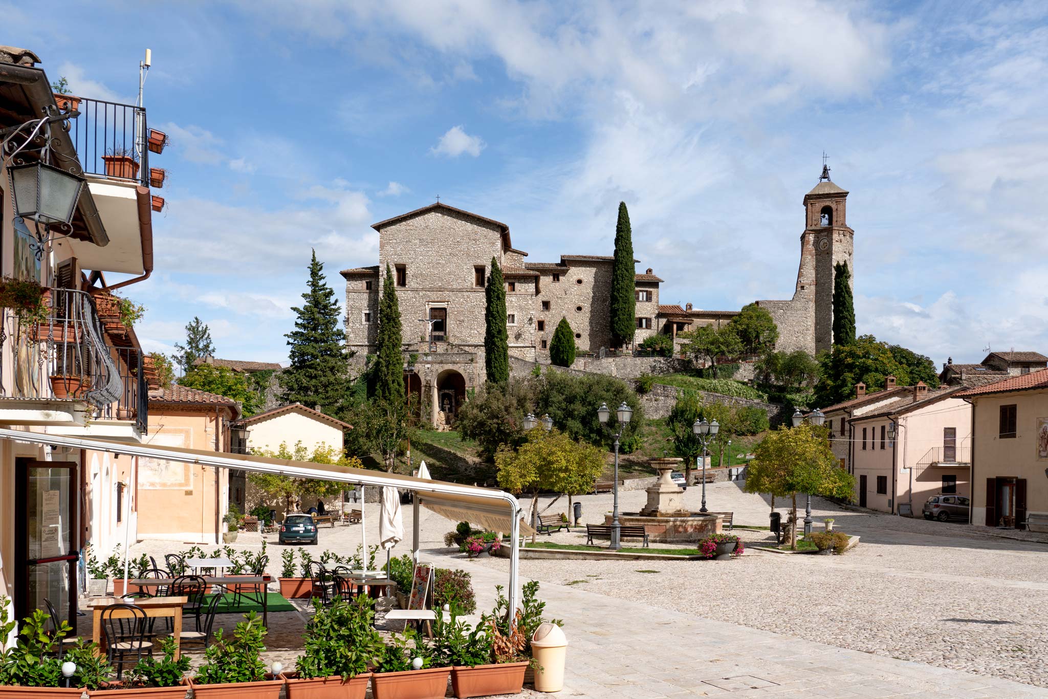 Greccio's main square, fountain and church near Rome