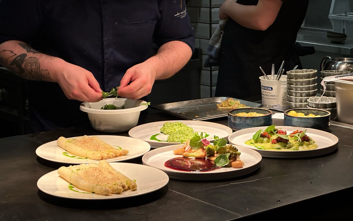 Plating up seasonal dishes at dreizehn by Gauster in Graz