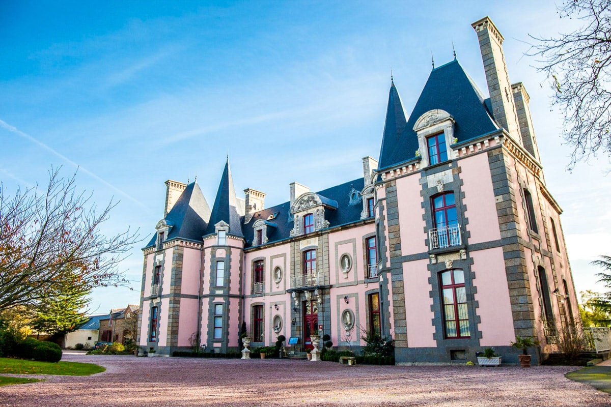 Exterior of the pink palace of Château Hôtel du Colombier, France